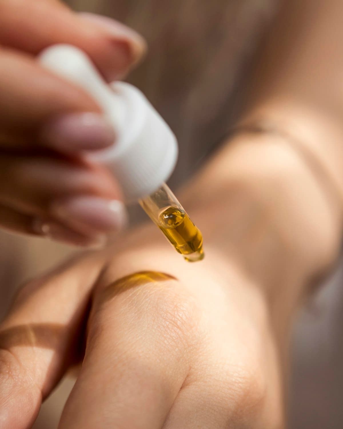 Massage oil being warmed in the therapist's hands before a session.